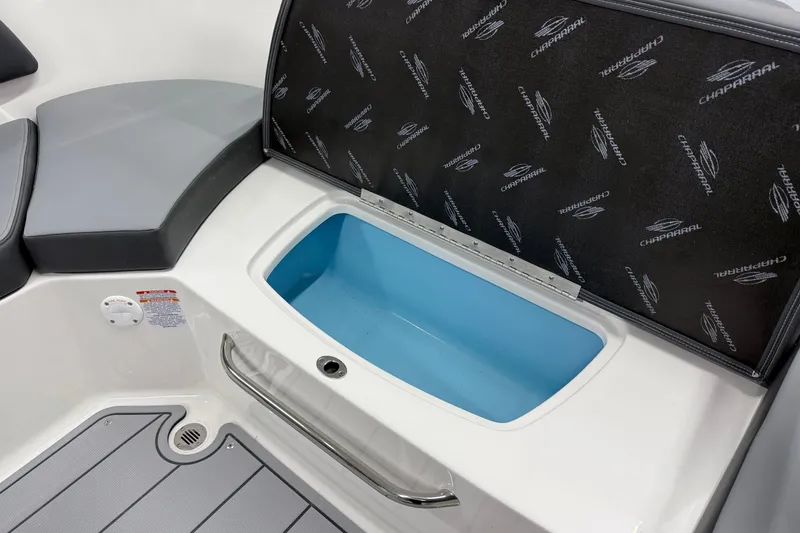 Slide: The Image of 2026 Chaparral 23 SSi boat interior storage compartment with cushioned seating. - 21