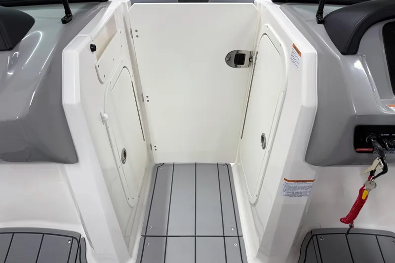 Slide: The Image of 2026 Chaparral 23 SSi boat interior with storage compartments and safety features. - 24