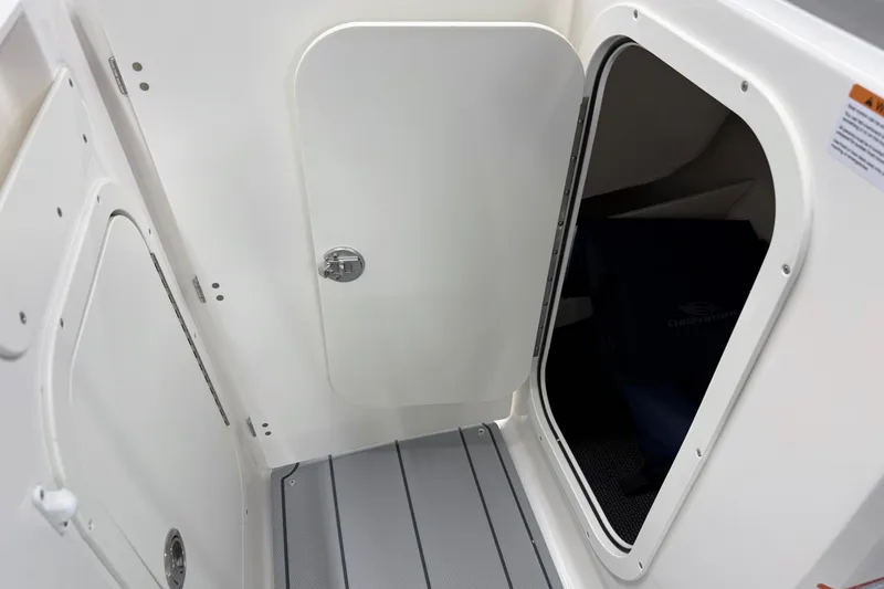Slide: The Image of 2026 Chaparral 23 SSi boat interior storage compartment with open door. - 25