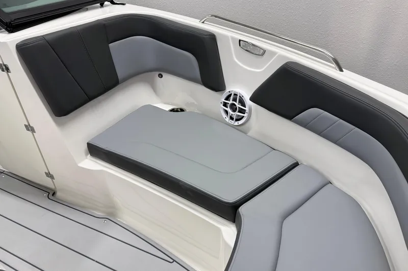 Slide: The Image of 2026 Chaparral 23 SSi boat interior with gray and black seating, speaker detail. - 28