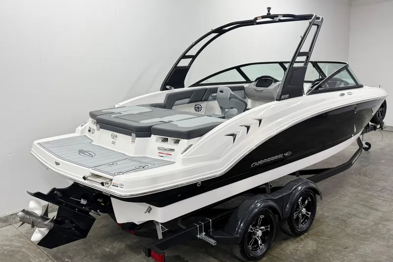Slide: The Image of 2026 Chaparral 23 SSi boat on trailer, sleek design, black and white exterior. - 3