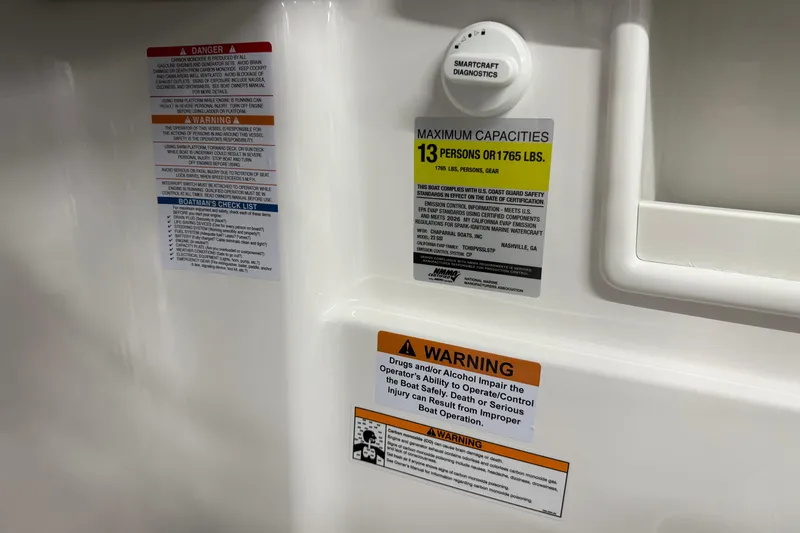 Slide: The Image of Safety and capacity labels on 2026 Chaparral 23 SSi boat interior. - 31