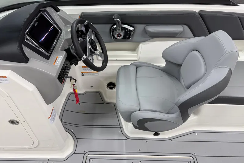 Slide: The Image of 2026 Chaparral 23 SSi boat interior with steering wheel and captain's seat. - 9