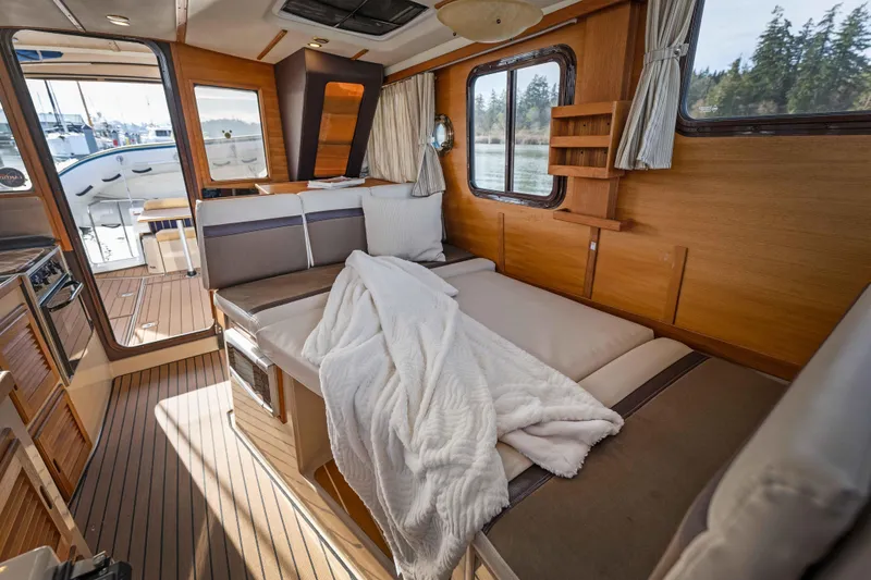 Slide: The Image of Interior of 2014 Ranger Tug R-31 CB with cozy bed and wooden finish. - 10