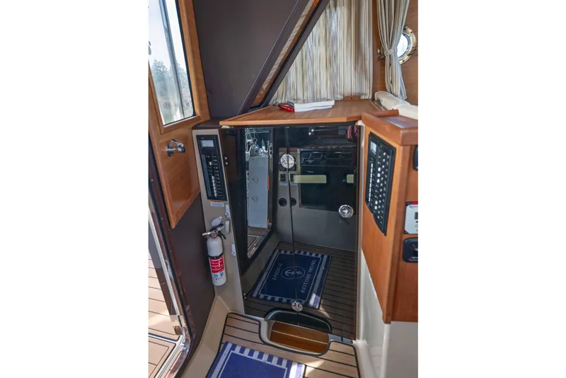 Slide: The Image of 2014 Ranger Tug R-31 CB interior with control panel, fire extinguisher, and nautical decor. - 13