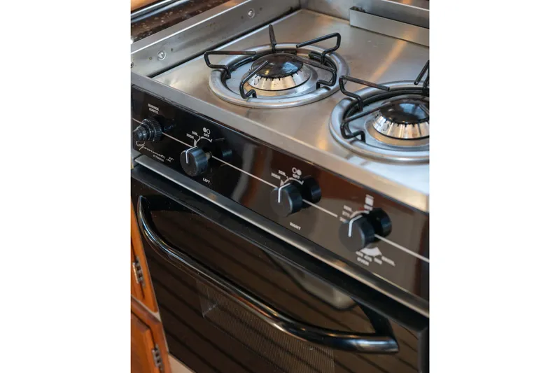 Slide: The Image of Stainless steel stove with two burners on a 2014 Ranger Tug R-31 CB boat. - 14