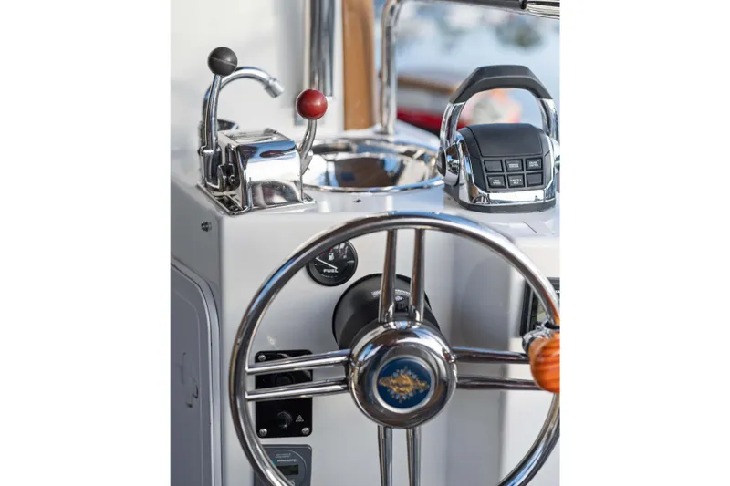 Slide: The Image of 2014 Ranger Tug R-31 CB helm with steering wheel and control levers. - 22