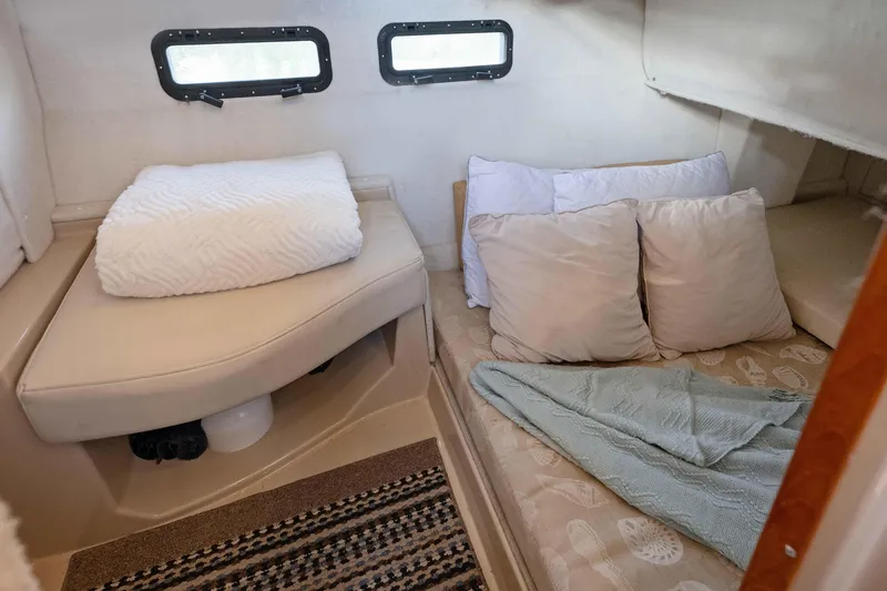 Slide: The Image of 2014 Ranger Tug R-31 CB cabin interior with cozy bedding and porthole windows. - 24