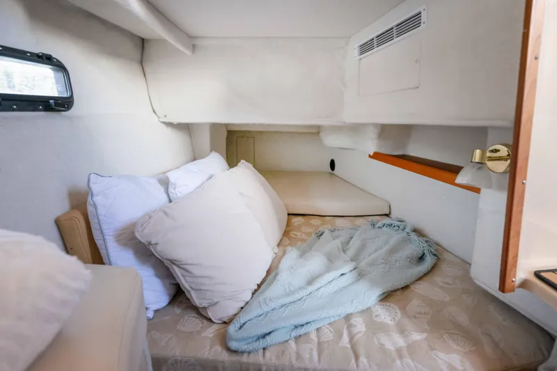 Slide: The Image of Cozy cabin interior of 2014 Ranger Tug R-31 CB with pillows and blanket. - 25