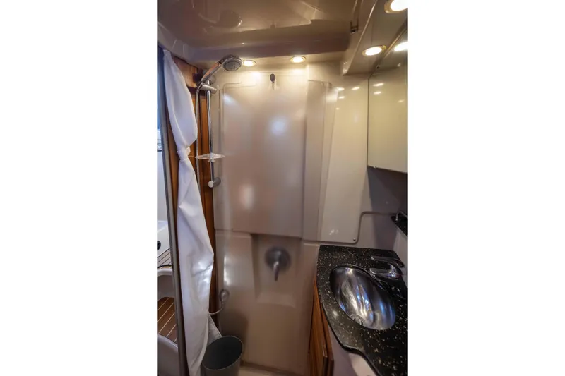 Slide: The Image of 2014 Ranger Tug R-31 CB bathroom with shower, sink, and modern lighting. - 30