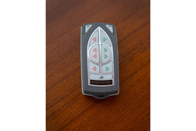 Slide: The Image of Remote control for 2014 Ranger Tug R-31 CB on wooden surface. - 40