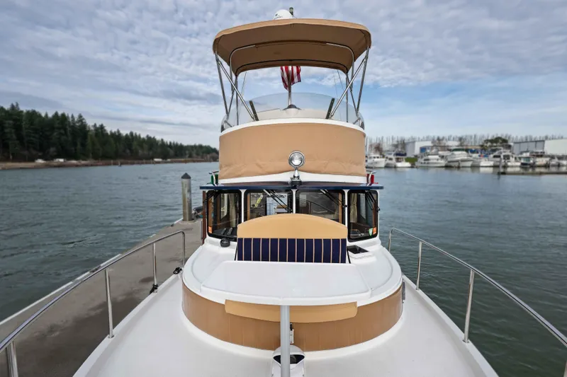 Slide: The Image of 2014 Ranger Tug R-31 CB boat docked at marina with scenic water view. - 49
