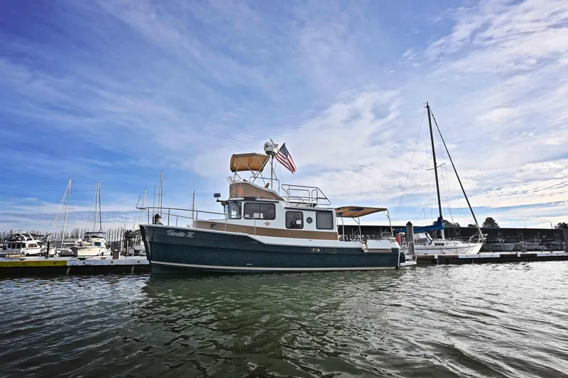 Slide: The Image of 2014 Ranger Tug R-31 CB docked at marina under blue sky. - 55