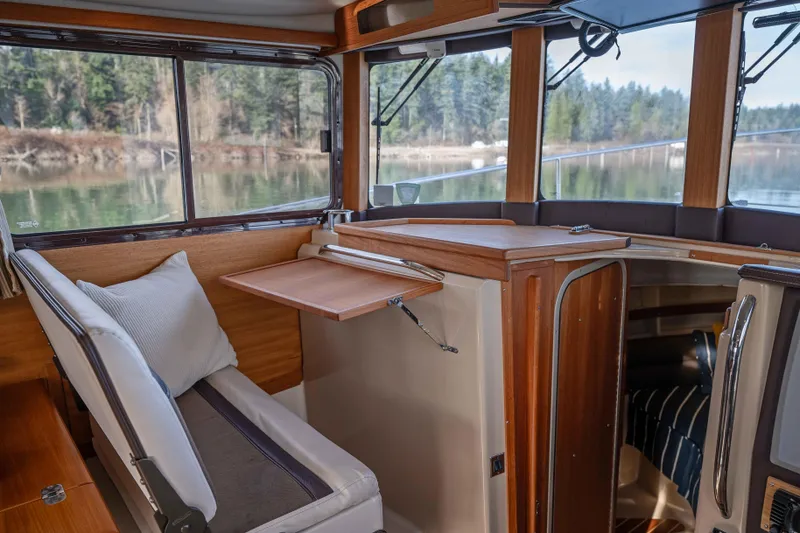 Slide: The Image of Interior of 2014 Ranger Tug R-31 CB with wood accents and scenic window view. - 8