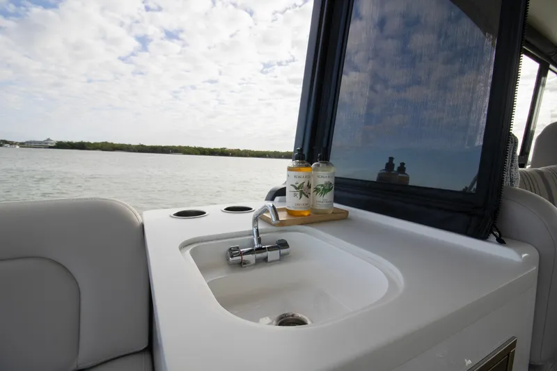 Slide: The Image of 2025 MJM 38 X boat interior with open storage compartments and cushioned seating. - 19