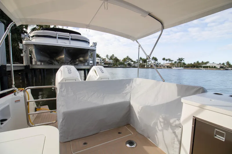 Slide: The Image of 2025 MJM 38 X boat cruising on a sunny day near waterfront homes. - 3