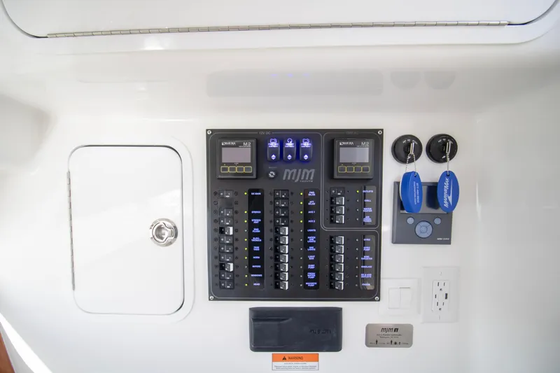 Slide: The Image of Control panel and outlets on 2025 MJM 38 X boat interior. - 53
