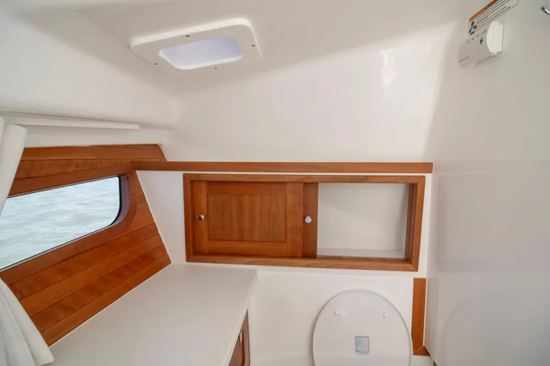 Slide: The Image of 2025 MJM 38 X yacht interior with wooden cabinetry and window. - 55