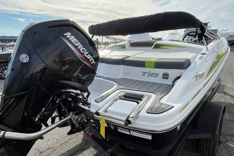Slide: The Image of 2023 Tahoe T18 boat with Mercury engine, docked on a sunny day. - 2
