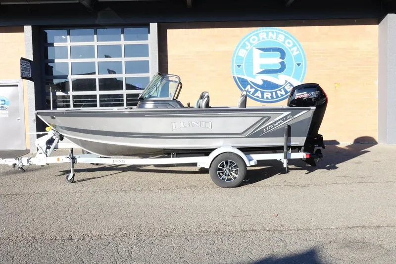 The Image of 2026 Lund 1775 Impact XS Sport boat on trailer at Bjornson Marine. - 1