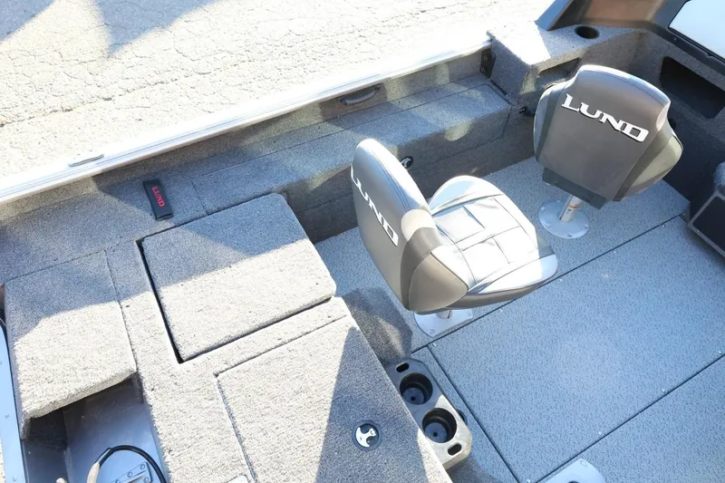 Slide: The Image of 2026 Lund 1775 Impact XS Sport boat interior with seating and storage compartments. - 11
