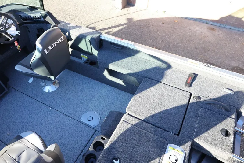 Slide: The Image of 2026 Lund 1775 Impact XS Sport boat interior with seating and storage compartments. - 12