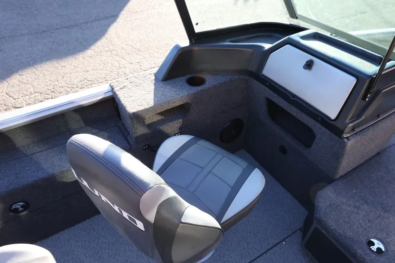 Slide: The Image of 2026 Lund 1775 Impact XS Sport boat interior with gray seating and storage compartments. - 14
