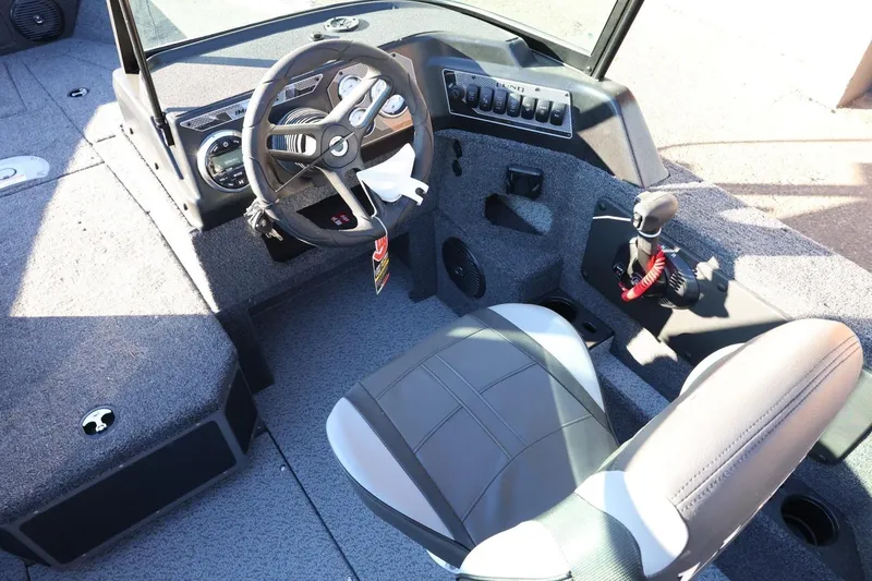 Slide: The Image of 2026 Lund 1775 Impact XS Sport boat interior with steering wheel and controls. - 15