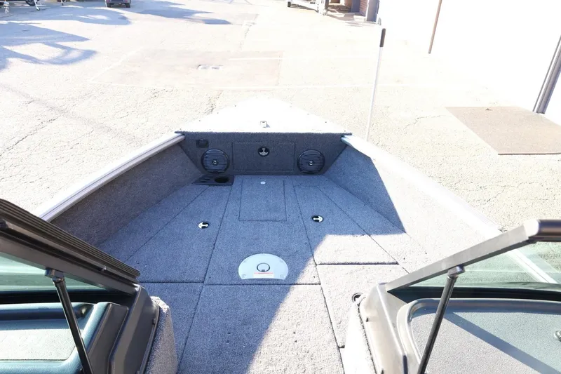 Slide: The Image of 2026 Lund 1775 Impact XS Sport boat interior, featuring spacious deck and storage compartments. - 16