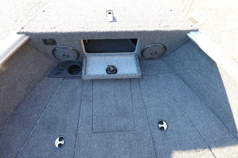 Slide: The Image of 2026 Lund 1775 Impact XS Sport boat interior with carpeted deck and storage compartments. - 18