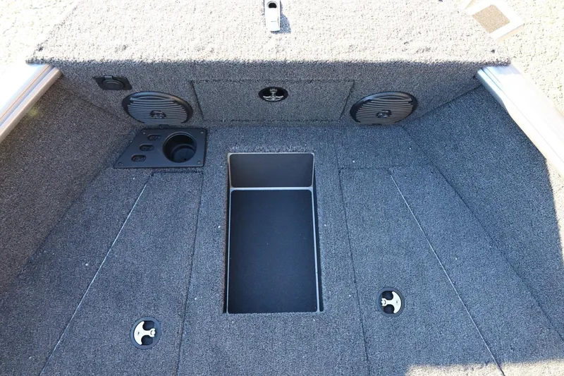 Slide: The Image of 2026 Lund 1775 Impact XS Sport boat interior with speakers and storage compartment. - 19