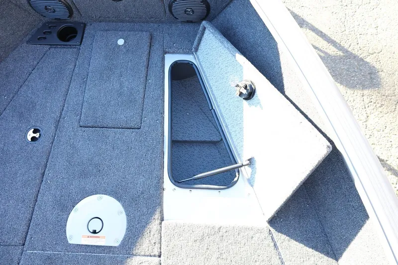 Slide: The Image of 2026 Lund 1775 Impact XS Sport boat interior storage compartment open. - 20