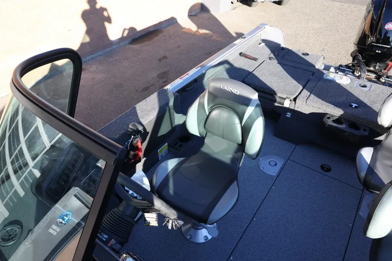 Slide: The Image of 2026 Lund 1775 Impact XS Sport boat interior with seating and controls. - 23