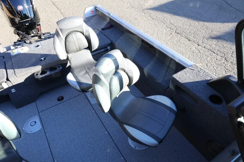 Slide: The Image of 2026 Lund 1775 Impact XS Sport boat interior with swivel seats and motor. - 24
