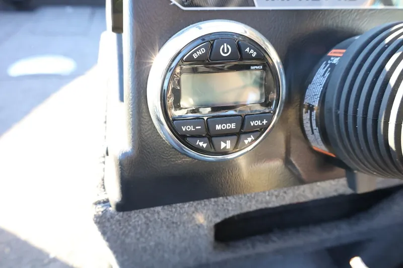 Slide: The Image of Control panel of 2026 Lund 1775 Impact XS Sport boat, featuring audio system controls. - 26