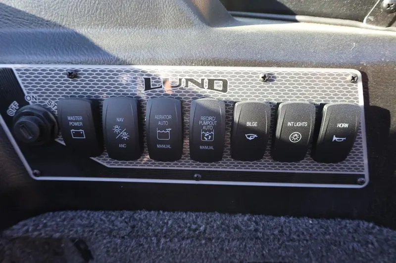 Slide: The Image of Control panel of 2026 Lund 1775 Impact XS Sport boat with various switches. - 28