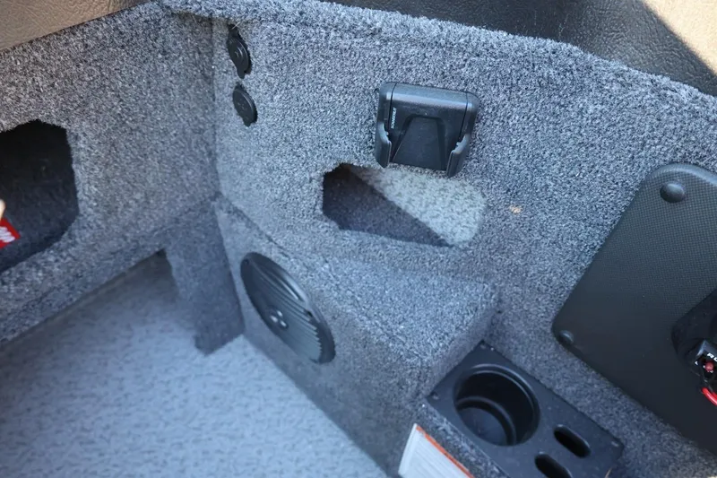 Slide: The Image of Interior of 2026 Lund 1775 Impact XS Sport boat with carpeted storage and speaker. - 29