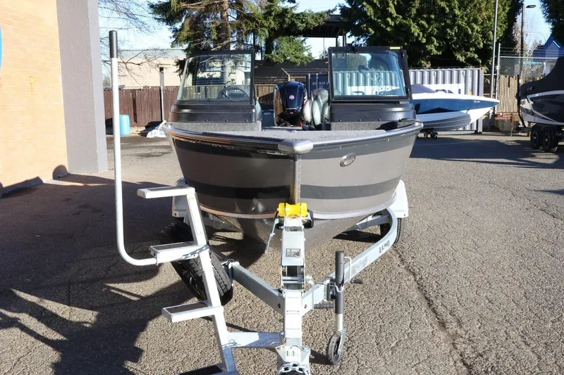Slide: The Image of 2026 Lund 1775 Impact XS Sport boat on trailer, parked outdoors. - 3