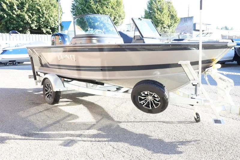 Slide: The Image of 2026 Lund 1775 Impact XS Sport boat on trailer, parked outdoors. - 4