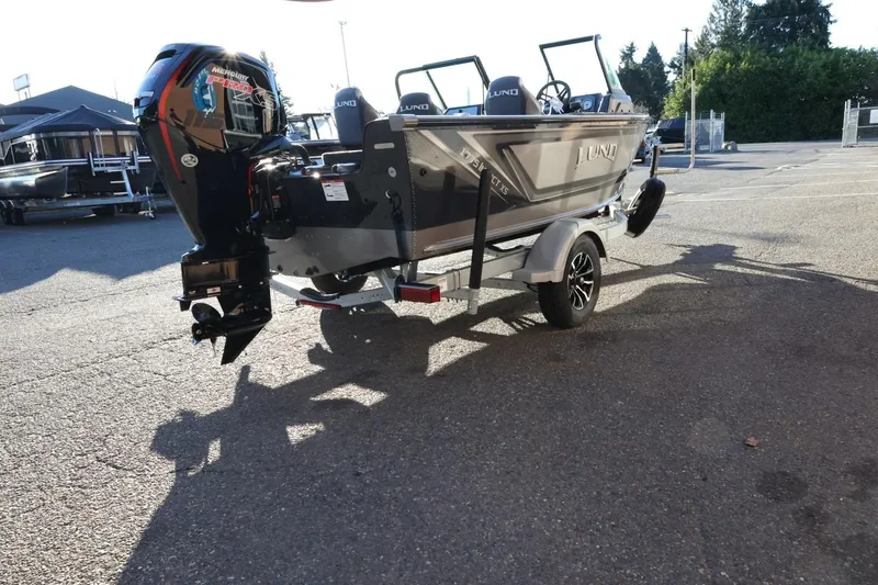 Slide: The Image of 2026 Lund 1775 Impact XS Sport boat on trailer, parked outdoors, rear view. - 6