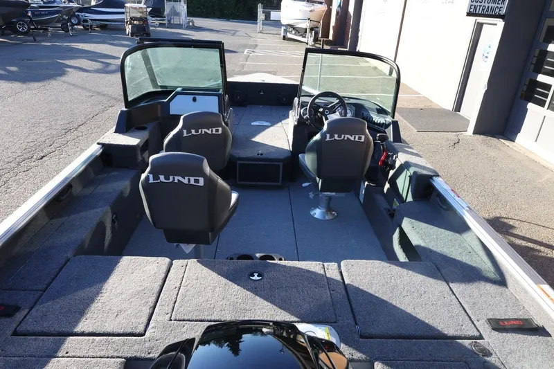 Slide: The Image of 2026 Lund 1775 Impact XS Sport boat interior with seating and steering console. - 9