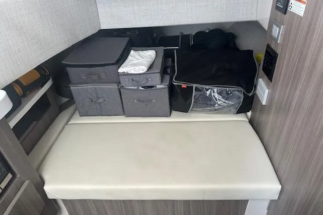 Slide: The Image of Interior storage area of 2022 Regal 38 SAV boat with organized containers. - 16