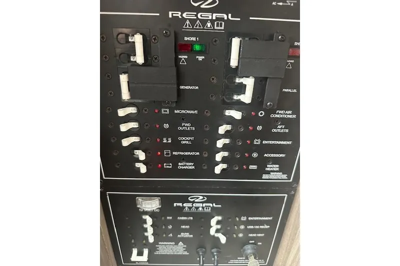 Slide: The Image of Control panel of a 2022 Regal 38 SAV boat with labeled switches and indicators. - 19