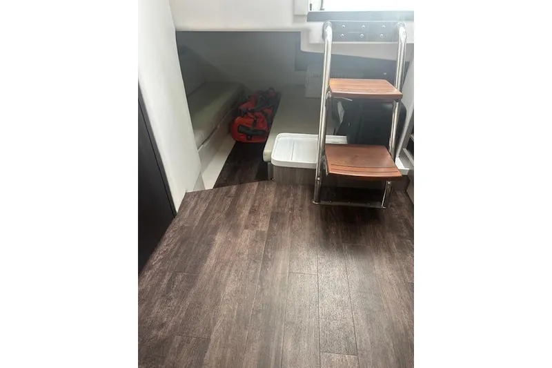 Slide: The Image of Interior of 2022 Regal 38 SAV boat with wooden steps and storage area. - 20