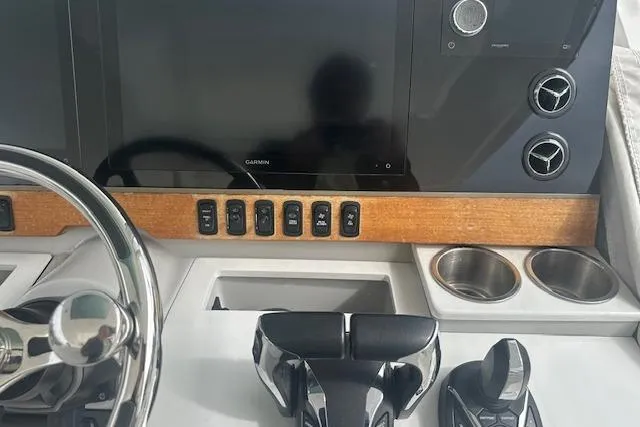 Slide: The Image of Helm of 2022 Regal 38 SAV boat with Garmin display and controls. - 24