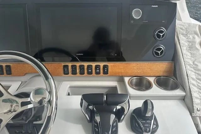 Slide: The Image of Control panel of 2022 Regal 38 SAV boat with steering wheel and navigation screens. - 25