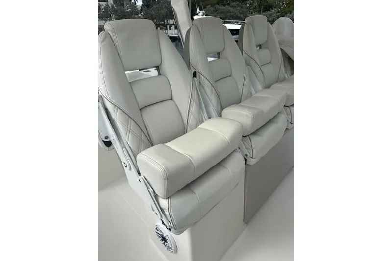 Slide: The Image of Luxurious seating on 2022 Regal 38 SAV boat, featuring plush, light-colored upholstery. - 28