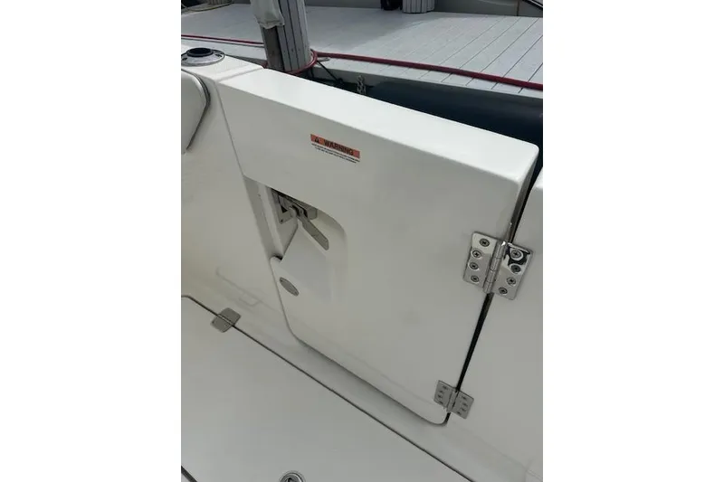Slide: The Image of 2022 Regal 38 SAV boat door with stainless steel hinges and warning label. - 32