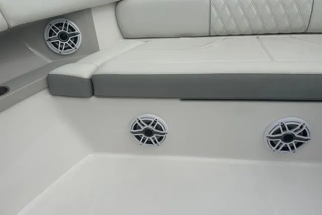 Slide: The Image of 2022 Regal 38 SAV boat interior with cushioned seating and built-in speakers. - 36