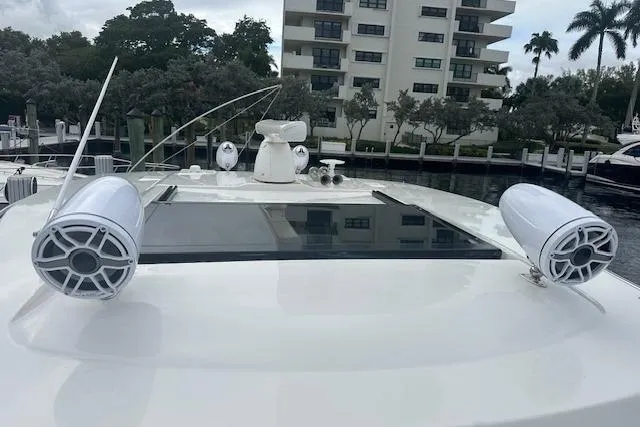 Slide: The Image of 2022 Regal 38 SAV yacht with speakers, docked near waterfront buildings. - 38